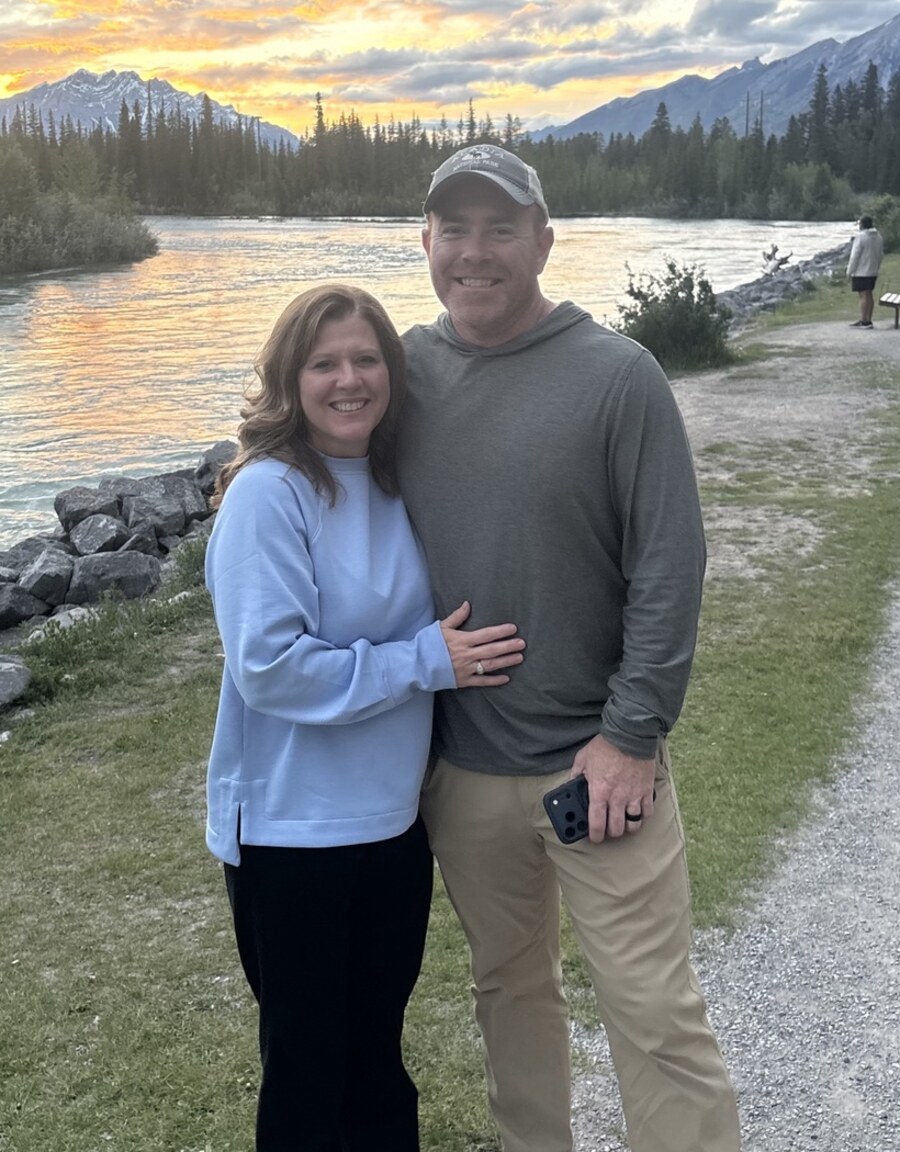 Joshua Devore and his wife outdoors by a mountain river