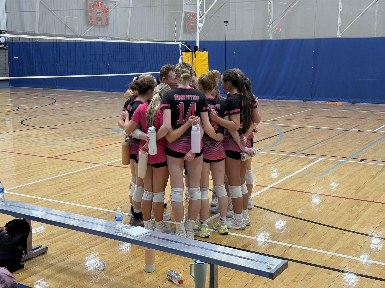 BAMVC players gathered in a team huddle on the court